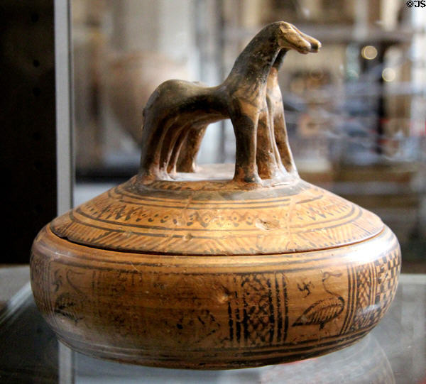 Athenian terracotta Pyxis (box) with modeled horses (c740 BCE) decorated in geometric style at Louvre Museum. Paris, France.