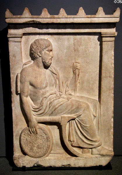 Funerary stela of bronze smith Sosinos of Gortyn seated with bellows in right hand (c410-400 BCE) from Mount Pentelikon near Athens at Louvre Museum. Paris, France.