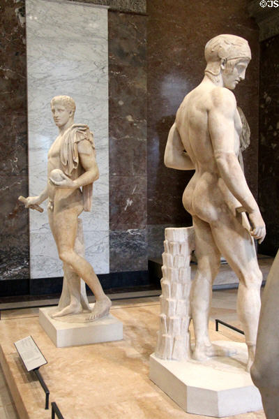 Classical Greek male nude marble statues (430-370 BCE) at Louvre Museum. Paris, France.