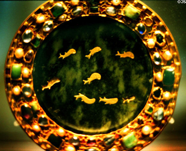 Gold dolphins inlaid on paten of serpentine (1stC BCE or CE) within later frame with precious stones (9thC) at Louvre Museum. Paris, France.