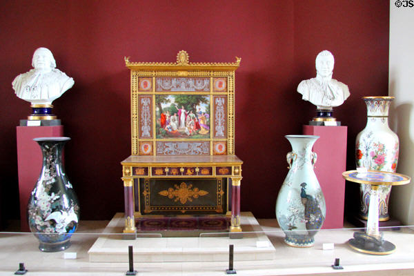 Sèvres desk of the Muses (1815-30) flanked by other porcelain showpieces at Sèvres National Ceramic Museum. Paris, France.