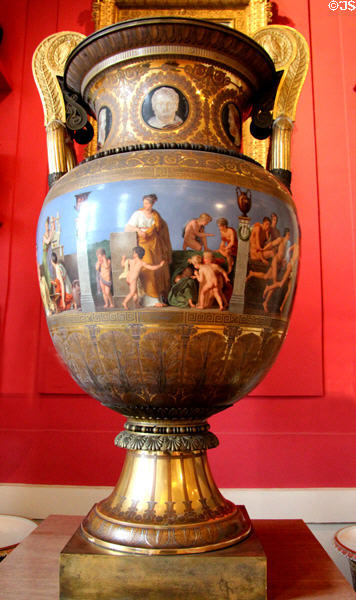 Sèvres porcelain Etruscan-style vase (1832) showing Education of young Greeks by Antoine Béranger flanked by other porcelain showpieces at Sèvres National Ceramic Museum. Paris, France.
