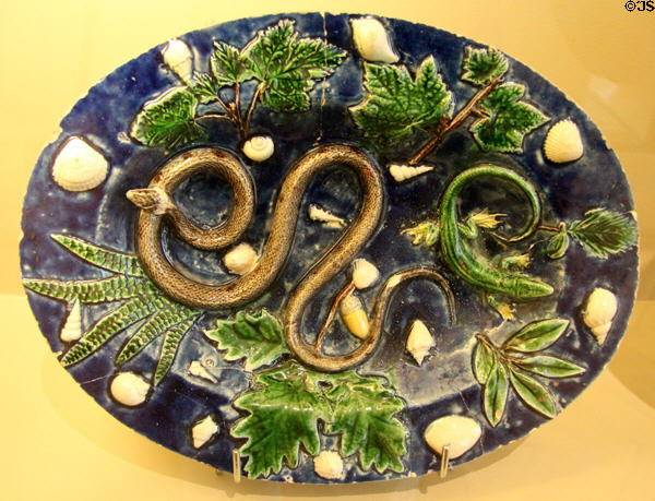 Glazed earthenware platter with moulded snake, lizard, shells & leaves (1580-1630) from France at Sèvres National Ceramic Museum. Paris, France.