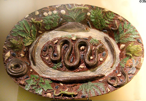 Glazed earthenware platter with moulded snake, fish & other creatures (1580-1630) at Sèvres National Ceramic Museum. Paris, France.