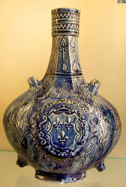 Ceramic pilgrim's flask (gourde à passants) with arms of France (1600-30) from Nevers, France at Sèvres National Ceramic Museum. Paris, France.