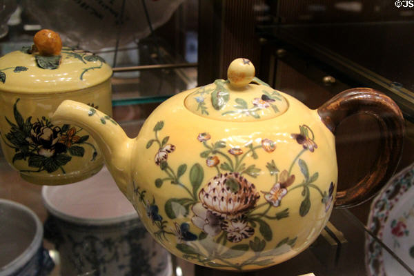 Ceramic teapot painted with flowers on yellow base (c1760-5) by Joseph II Fauchier at Sèvres National Ceramic Museum. Paris, France.