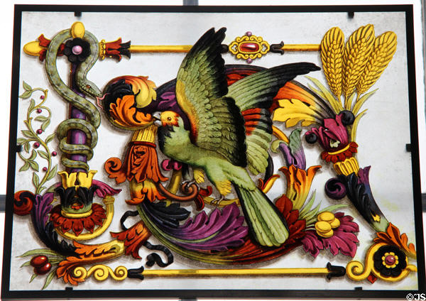 Painted scene on glass of parrot & snake with garlands of plants at Sèvres National Ceramic Museum. Paris, France.