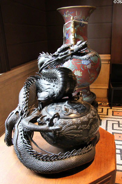 Chinese dragon holding covered bowl at Cernuschi Museum. Paris, France.