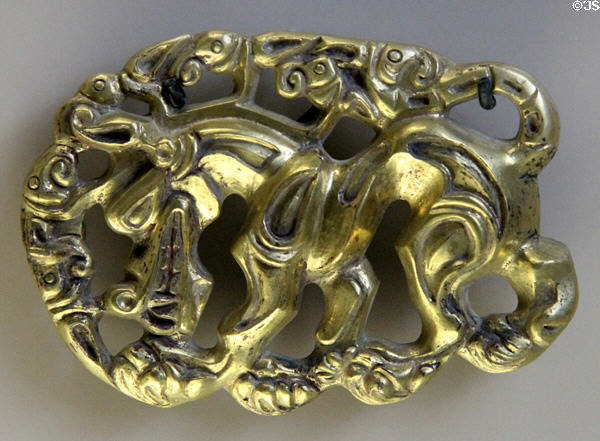 Mongolian bronze belt buckle showing horse fighting beast (c2ndC BCE) from Hungary at Cernuschi Museum. Paris, France.