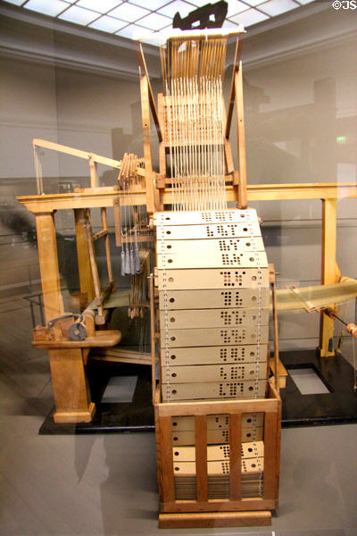 Punch card loom (1728) by Jean Philippe Falcon (shown as scale model Paris Expo 1855) at Arts et Metiers Museum. Paris, France.