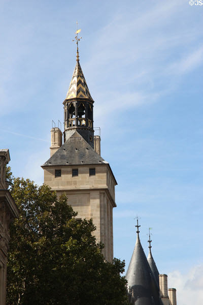 Clock tower in line with other towers at Conciergerie. Paris, France.