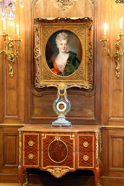 Portrait & lyre clock over cabinet in parlor at Cognacq-Jay Museum. Paris, France.