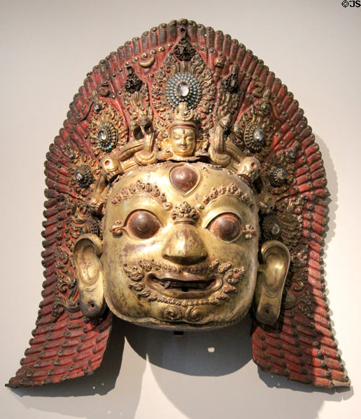 Gilded copper statue with gems of Siva mask (16th-17thC) from Nepal at Guimet Museum. Paris, France.