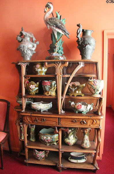 Display cabinet with Art Nouveau ceramics at Maxim's Art Nouveau Collection 1900. Paris, France.