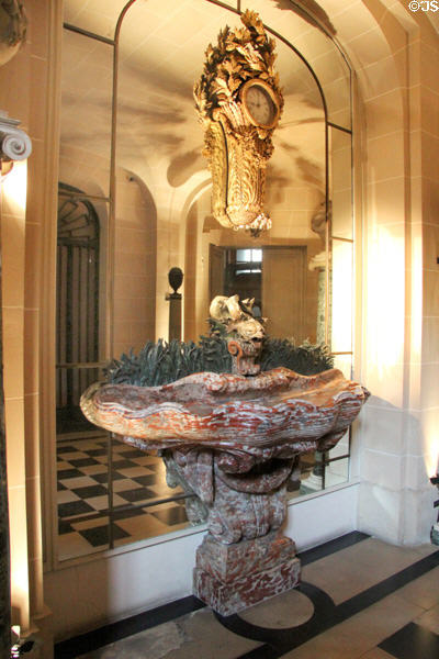 Hallway marble fountain before mirrored wall at Nissim de Camondo Museum. Paris, France.