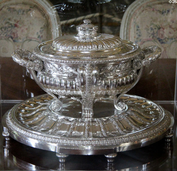 Covered silver serving bowl on platter in dining room at Nissim de Camondo Museum. Paris, France.