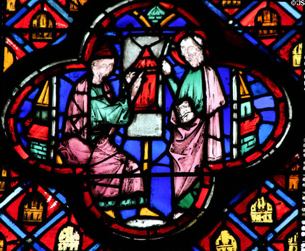 Saints with picture of tower stained glass scene at St Chapelle. Paris, France.