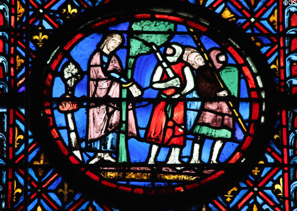 Man with departing soldiers stained glass scene at St Chapelle. Paris, France.
