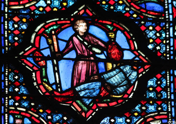 Man with decapitated head stained glass scene at St Chapelle. Paris, France.