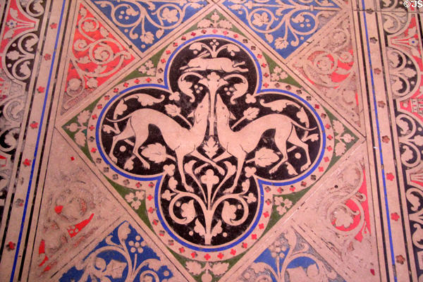 Inlaid stone floor detail with dogs chasing rabbit at St Chapelle. Paris, France.