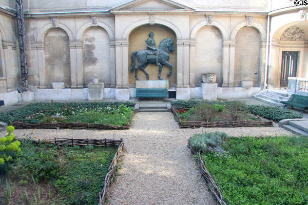 Courtyard of Carnavalet Museum with statue of Louis XIV. Paris, France.