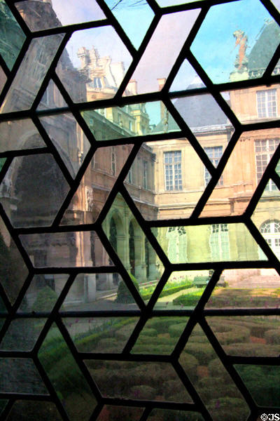 Courtyard seen through window panes at Carnavalet Museum. Paris, France.