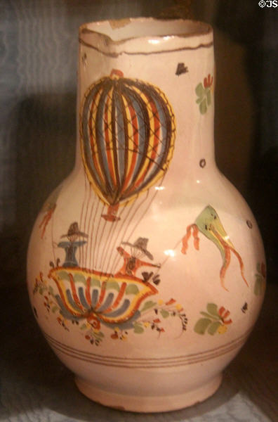 Earthenware pitcher painted with two people riding in balloon made by Faïence de Desvres at Carnavalet Museum. Paris, France.
