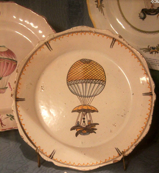 Earthenware dish painted with two people ascending in Blanchard balloon with parachute & steering made by Faience d'Ancy-le-Franc at Carnavalet Museum. Paris, France.