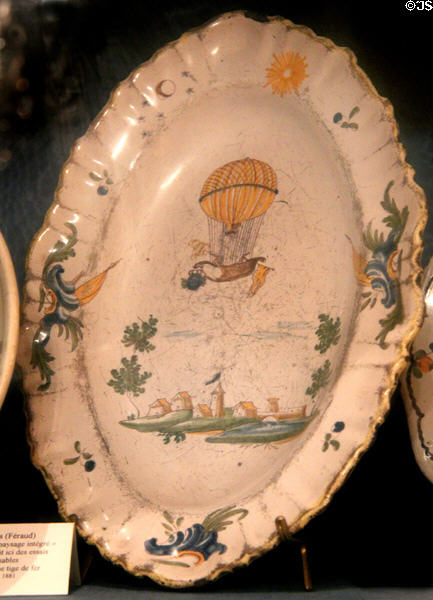 Earthenware oval plate commemorating Pierre Testu-Brissy who made the first observations of electrical charges in thunderclouds while ascended in a balloon, made by Faïence de Moustiers (Féraud) at Carnavalet Museum. Paris, France.