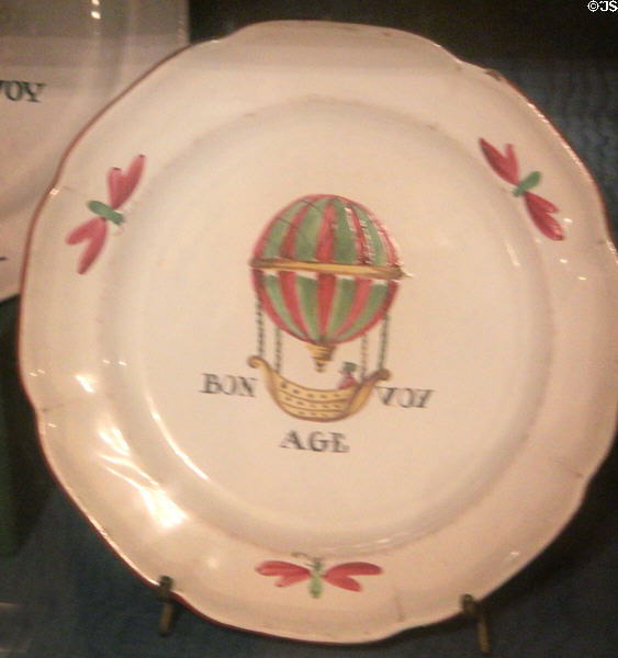 Earthenware Bon Voyage plate painted with person in hot air balloon made by Faience de l'Est at Carnavalet Museum. Paris, France.