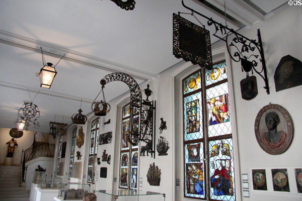 Gallery with antique metal shop signs & stained glass windows. Paris, France.