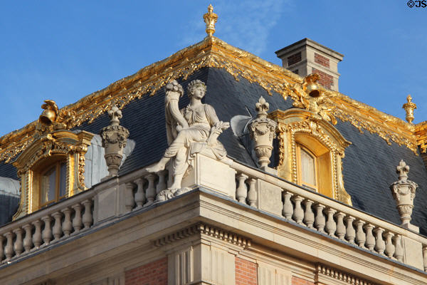 Figure with cornucopia on corner of gilded Mansard roof of Marble Court at Versailles Palace. Versailles, France.