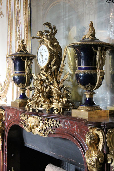 Two Sèvres porcelain & bronze vases named Mars & Minerva (1787) by Thomire for Louis XVI plus clock (1754) by Martinot & Gallien on mantel in Council Study at Versailles Palace. Versailles, France.
