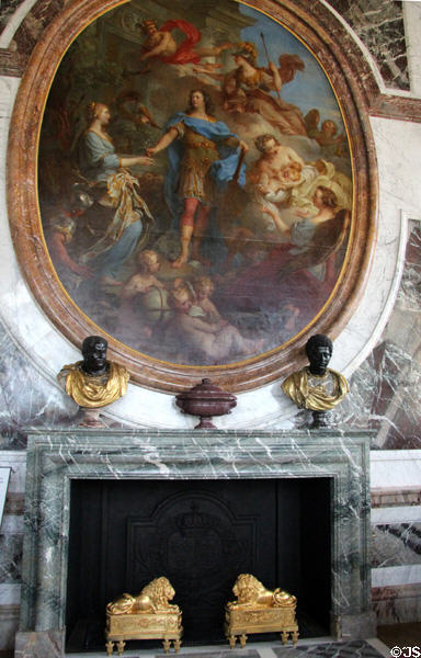 Oval mural symbolizing peace under Louis XIV (c1686) by Charles Le Brun over marble fireplace in Peace Room at Versailles Palace. Versailles, France.