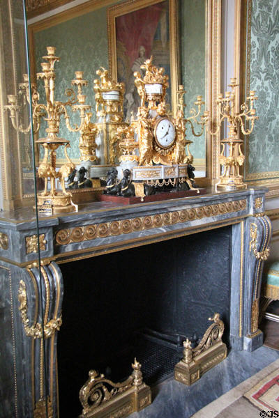 Fireplace with candelabras & mantle clock in Nobles antechamber of Queen's wing at Versailles Palace. Versailles, France.