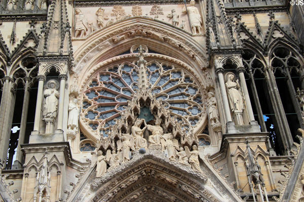 Coronation of Virgin Mary carving before rose window of Reims Cathedral. Reims, France.