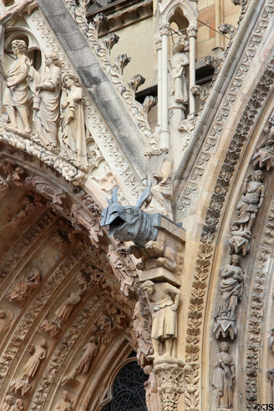 Rhinoceros gargoyle among carvings on Reims Cathedral. Reims, France.