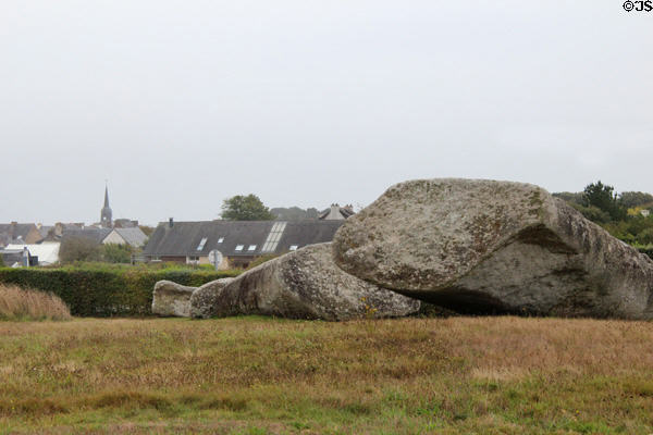 Great Broken Menhir with village in background at Locmariaquer Megalithic site. Locmariaquer, France.