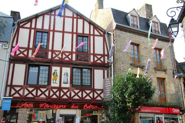 Street festooned with decorative fish in historic center. Auray, France.