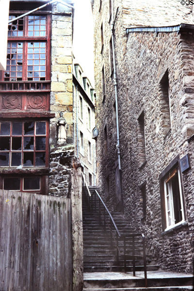 Antique houses on steep staircase street. St Malo, France.