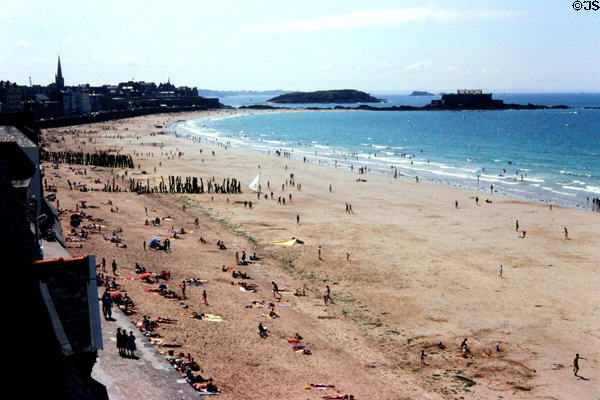 Bathers on sweeping beach. St Malo, France.