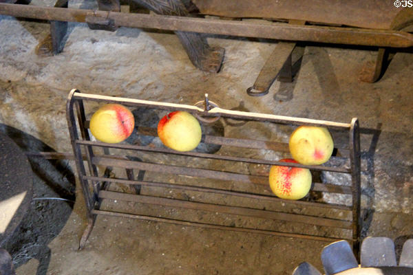 Rack for ripening fruit in front of fireplace in kitchen at Jacques Cartier Manor House Museum. St Malo, France.