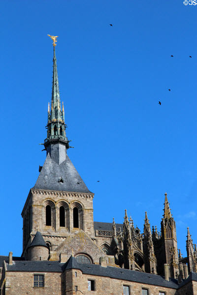 Mont-St-Michel abbey with spire crowned by Archangel Michael (late 19thC) by Emmanuel Frémiet. Mont-St-Michel, France.