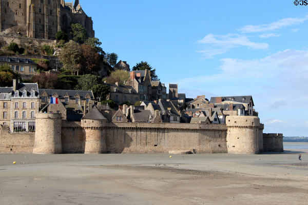 Mont-St-Michel town & walls seen from bridge. Mont-St-Michel, France.