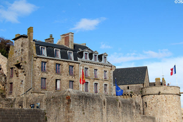 Old stone buildings with mansard roofs along walls. Mont-St-Michel, France.
