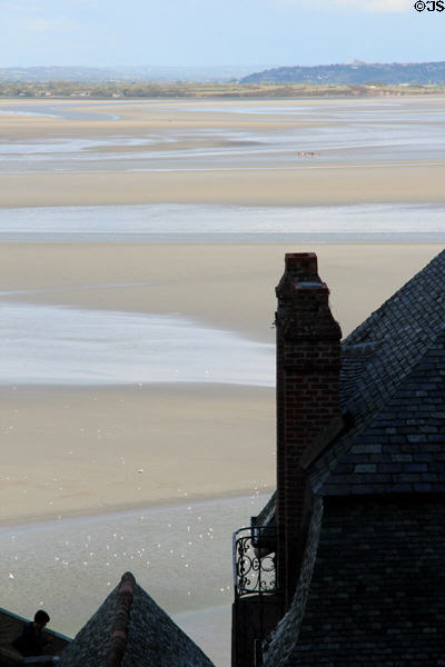 Roofs of Mont-St-Michel in profile against massive tidal flats. Mont-St-Michel, France.