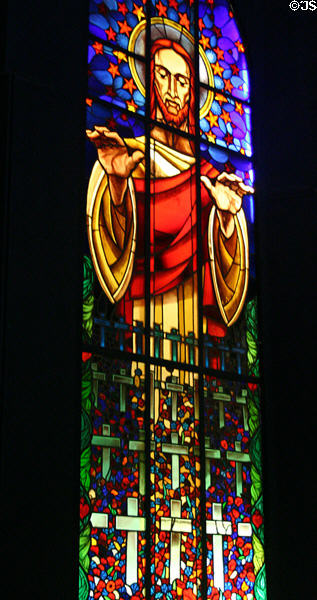 Image of Christ extending his blessing on stained glass window honoring soldiers killed in battle. Dieppe, France.