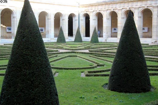 Conical trees in cloister at Caen City Hall. Caen, France.