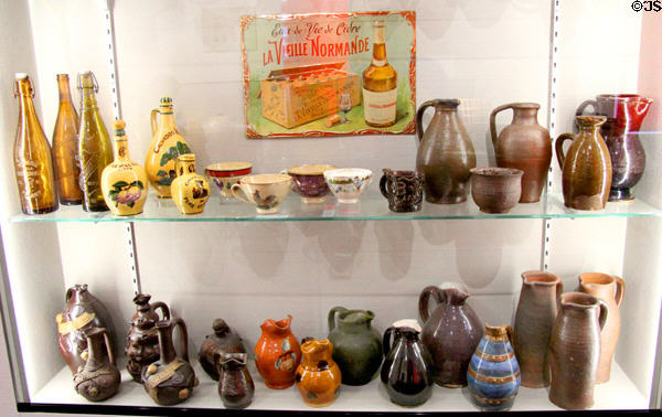Glass & ceramic serving vessels for Calvados, distilled apple cider of Normandy, at Museum of Normandy. Caen, France.