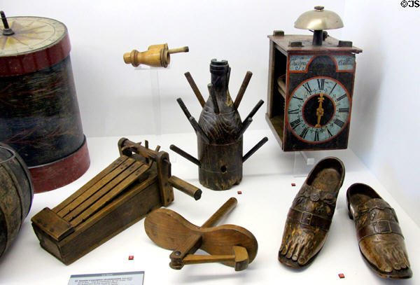 Wooden noisemakers, carved foot-like sabot shoes, bottle dryer & clock (1760) at Museum of Normandy. Caen, France.